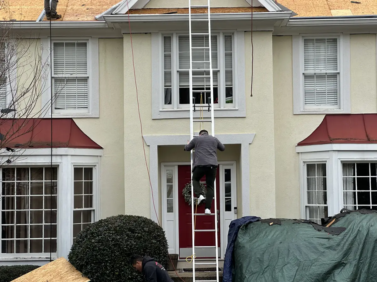 Owner climbing a roof to inspect it personally